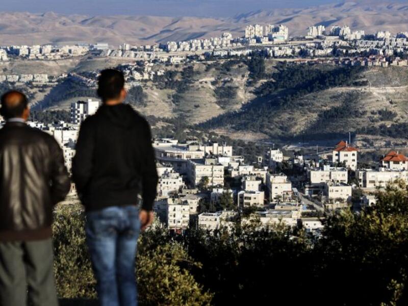 Palestinians look on after major settlement expansion was announced in the days following US President Donald Trump's January 20 inauguration (AFP/THOMAS COEX)