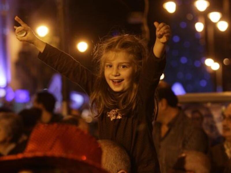 A child enjoys listening to a choir during Christmas Eve celebrations, in the Ashrafiyeh neighborhood of east Beirut.