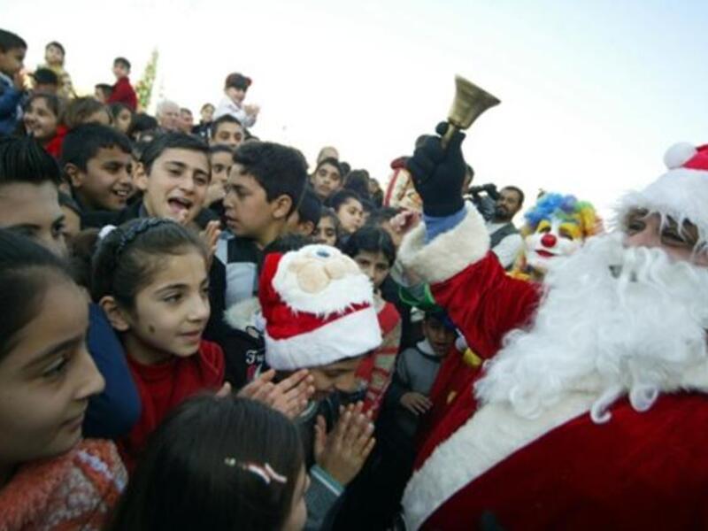 Mainly Iraqi Kurd children gather to greet Santa Claus in the northern Iraqi city of Arbil on Christmas eve.