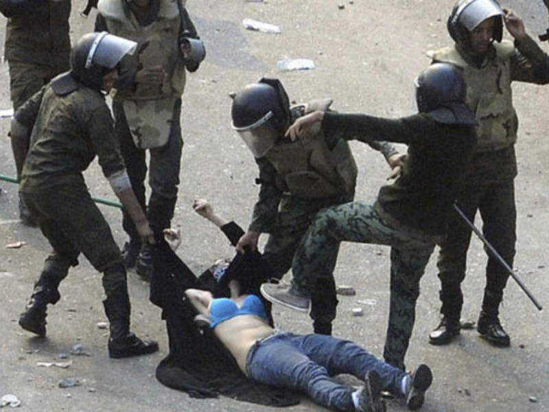 This 'blue-bra'd' girl is the iconic image for Egypt's post-revolution. Her graphic ordeal stands for indiscriminate violence to Muslim & Christian alike at the hands of the army. This veiled protestor was strewn in an undignified state when soldiers rough-handled her. Ripped apart at the seams, she diverted our eyes from the burning Churches.