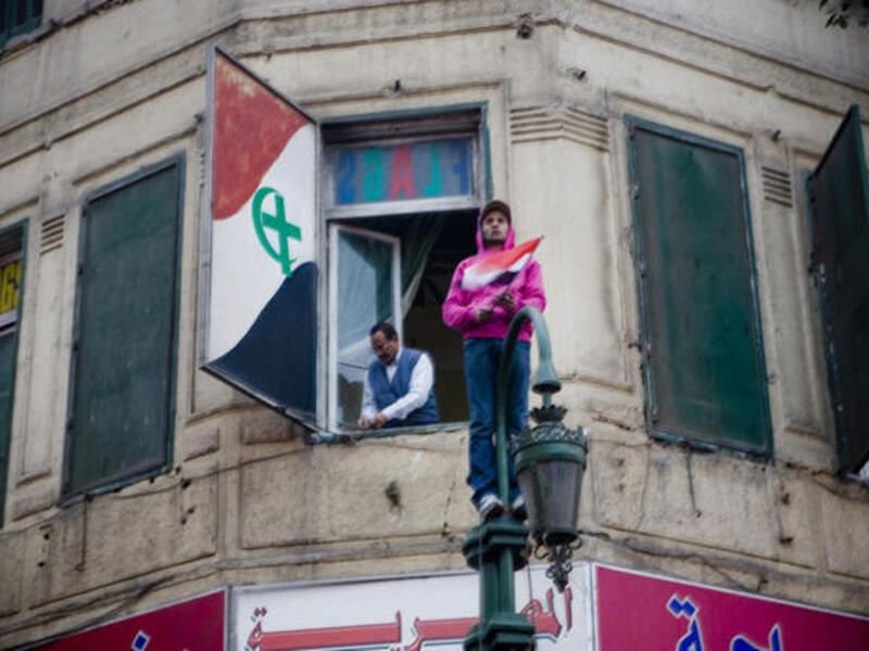 United we stand? The Unity flag of Christians & Muslim Egypt, raised jointly during the Jan 25 Revolution leading to the Mubarak ouster, belies a less harmonious story, since emerged. While Copts shared in the optimism of the revolution, with high hopes for change, they still have some way to attaining equal standing to their Muslims 'brothers'.