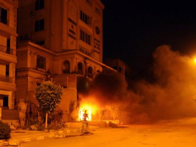 The armed men who ransacked the Muslim Brotherhood headquarters in Cairo on Monday had crossed a red line of violence, the ruling movement said, adding that it was considering action to defend itself.