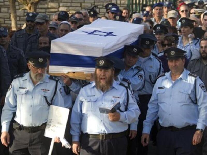 Israeli police officers carry the coffin of their comrade, Haifa Police Chief Ahuva Tomer, who died of her wounds after she was trapped with her car in raging fires which erupted in the Carmel Forest near Haifa.m