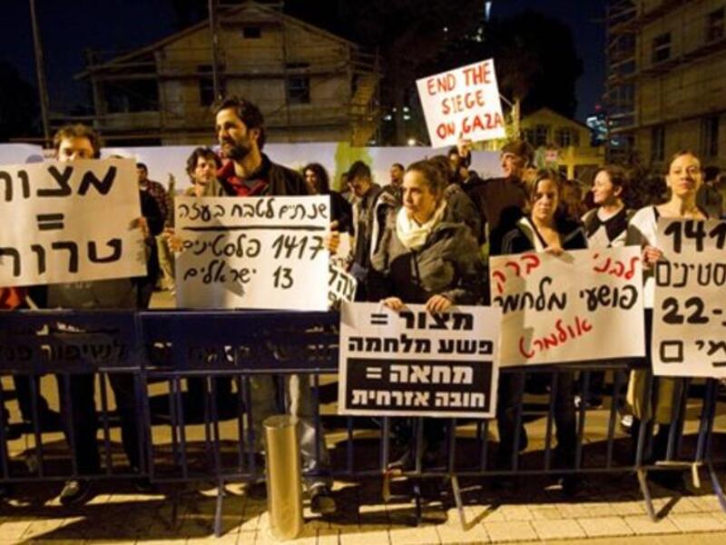 Around a hundred pacifist and leftist Israelis, holding up placards against the blockade imposed by Israel on Gaza since 2007, demonstrate outside the Jewish state's ministry of defense in Tel Aviv.