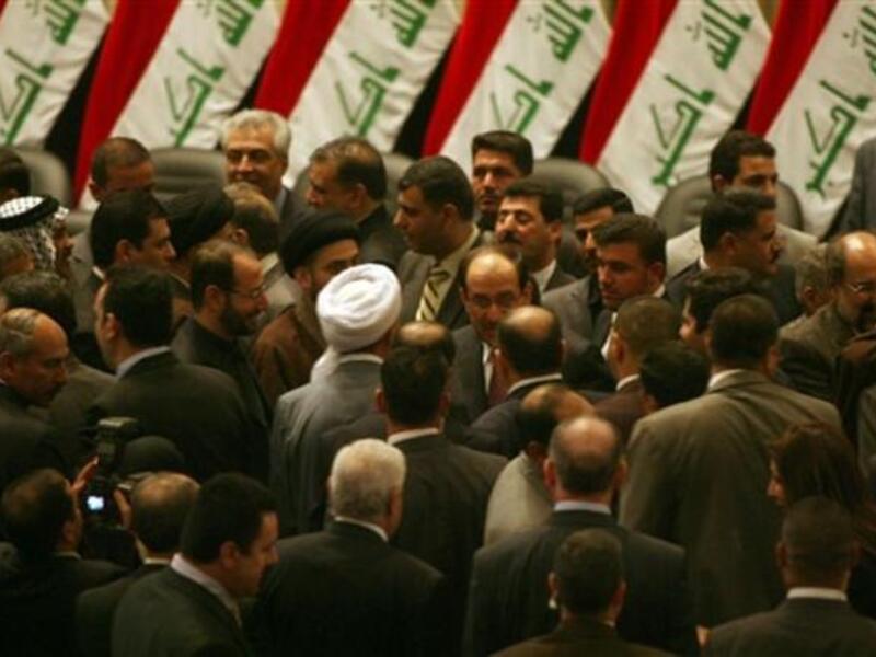 Iraqi Prime Minister Nuri al-Maliki is surrounded by lawmakers in the parliament after giving him a vote of confidence and adopted a 43-point program.