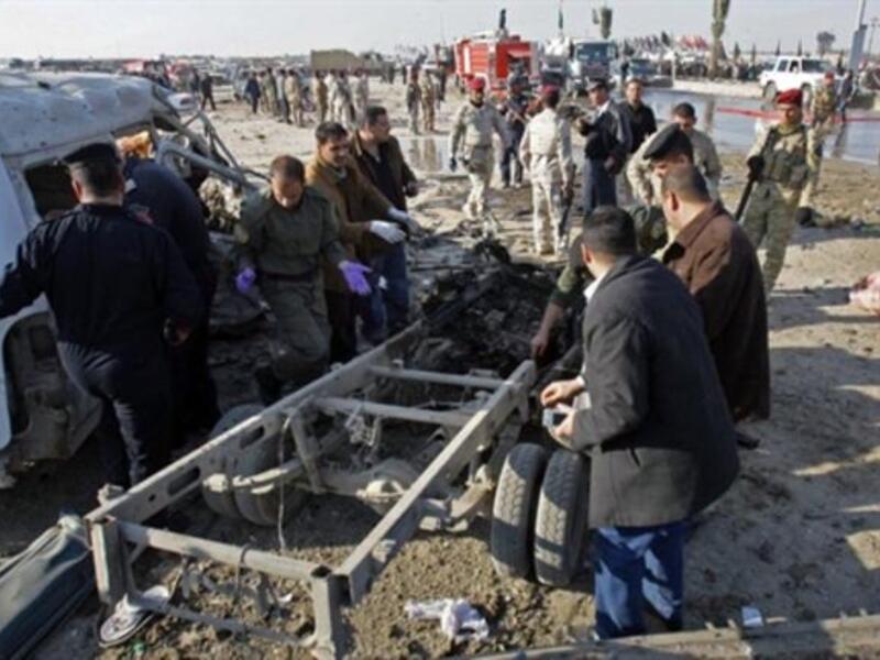 Members of Iraq security forces gather on the site of an explosion in Karbala.