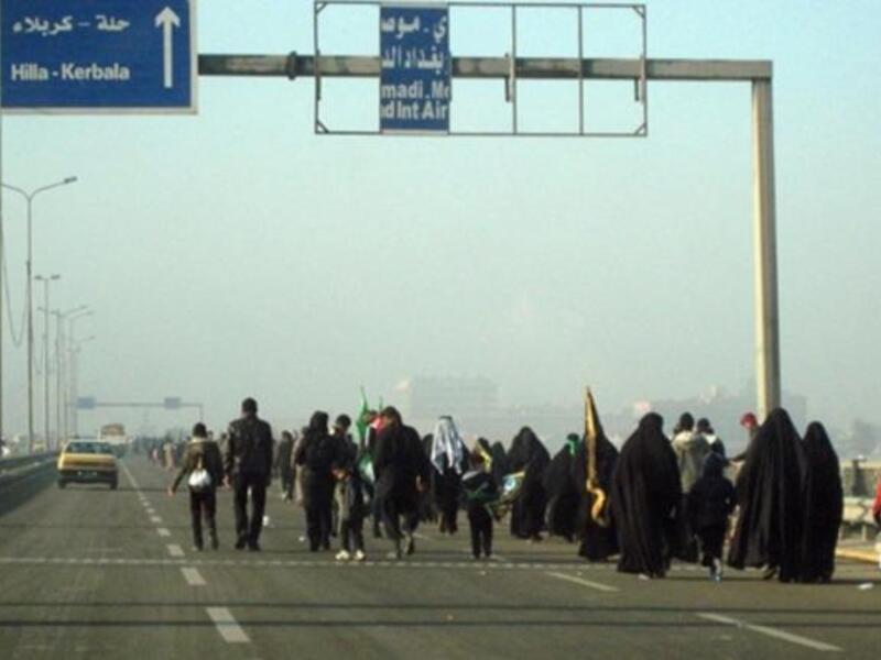 Shiite Muslim pilgrims walk on a main highway linking Baghdad to the central shrine city of Karbala, 120 kms south of the capital, on their way to attend the upcoming Arbaeen religious festival which marks the 40th day after Ashura.