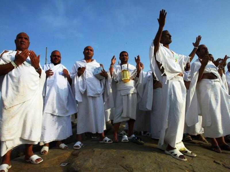 The Hajjis or pilgrims wear simple white clothes called Ihram: Male Muslims put on 2 clean, unstitched, white,
pieces of cloth. One sheet is wrapped around the lower part of the body and the other sheet around the upper body; the 
head should not be covered. Women may perform pilgrimage in the cloths they are wearing, without the face veil.

