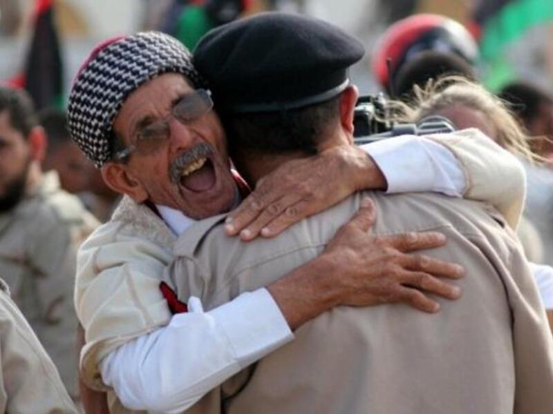 Libyans celebrate following the official day of liberation for the country in the eastern city of Benghazi on October 23, 2011
 just days after ousted Colonel Kadhafi was captured and killed.
