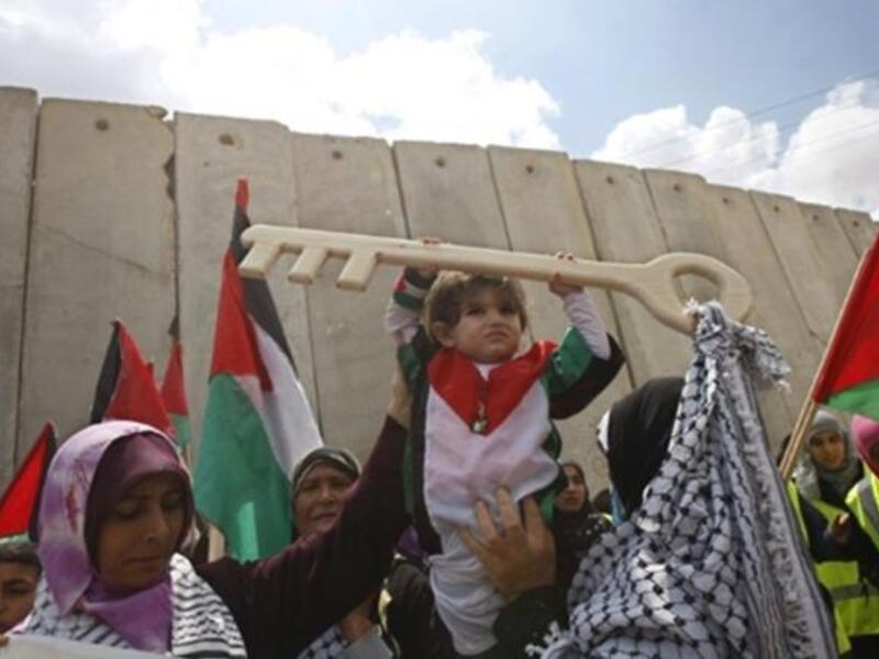 Rafah Raid : A Palestinian child holds a key made of wood, representing the key of her home snatched from her family during the creation of the state of Israel, at the Rafah border terminal between Egypt and the southern Gaza Strip, on May 15, 2011, during a rally to mark the Nakba.