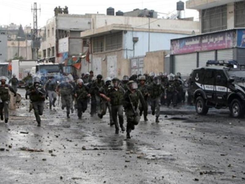 Jerusalem Jossles with its occupied side : Israeli border police take position during clashes with Palestinian demonstrators in the Shufat refugee camp on the outskirts of Jerusalem on May 15.