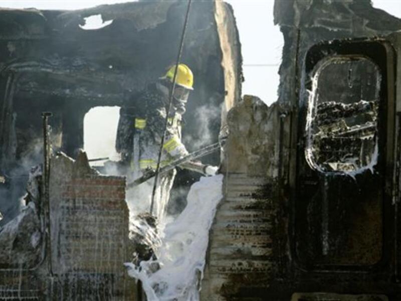 Israeli fire fighters are still trying to extinguish the flames of a burning train wreck.