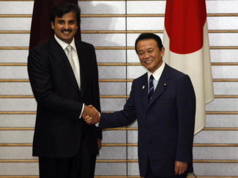 Sheikh Tamim Bin Hamad Al Thani is greeted by Japanese Prime Minister Taro Aso before a meeting in Tokyo (Getty)