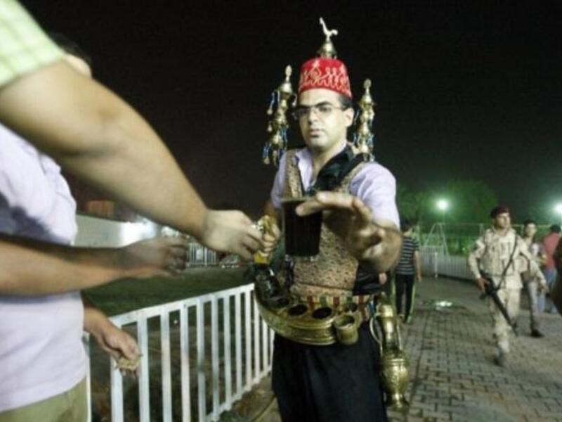 Iraq, Baghdad: An Iraqi serves Ramadan drinks (Jallab -a date juice, with grape molasses and rose water served with raw pine kernels), while mid-Ramadan news of 7 pulled from a south Baghdad, Sunni mosque, and killed execution-style breaks in this sacred month.