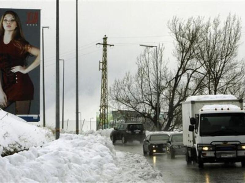 Traffic moves slowly in both directions on the main highway linking Beirut to Damascus near the mountain village of Sawfar during a snow storm which hit the Mediterranean country.
