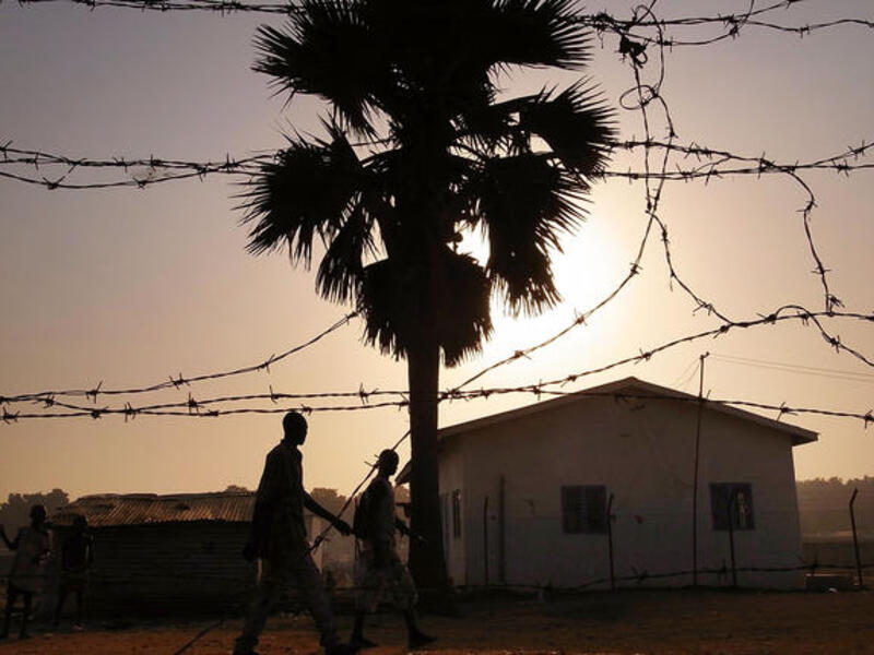 Men walk down a road in an area for displaced Sudanese in the southern Sudanese city of Juba, Sudan.