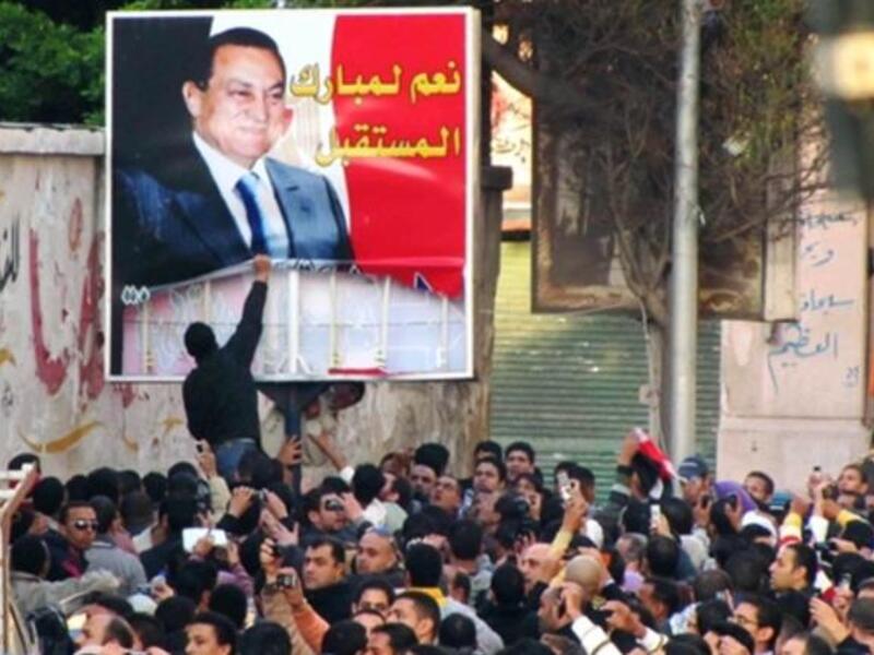 EGYPT: Egyptian demonstrators tear down a poster of Egyptian President Hosni Mubarak in the Mediterranean coastal city of Alexandria on January 25, 2011.