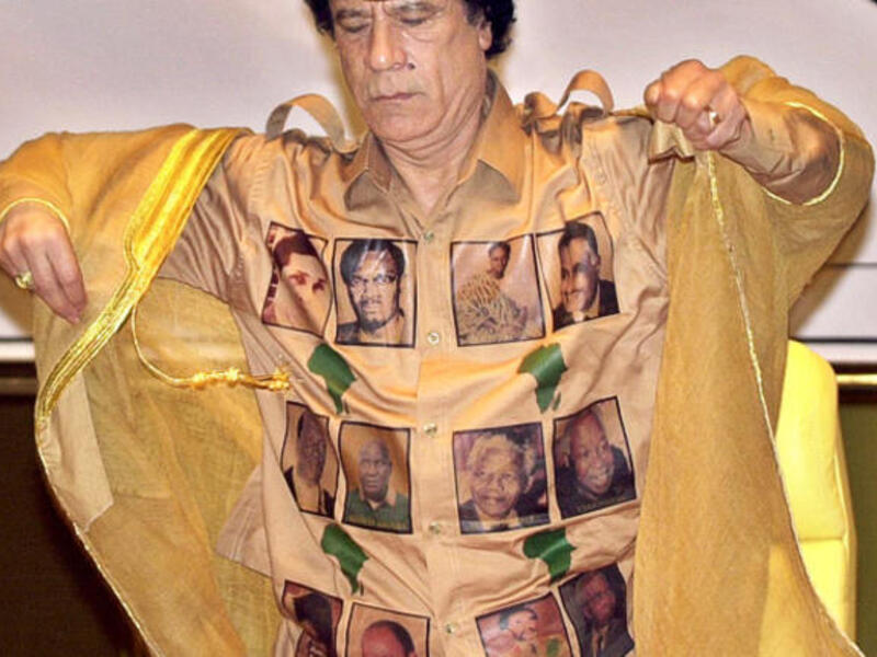 Proudly bearing his African 'kingdom's' heroes for all to get a closer look at. Leader of the African Union sports the ultimate Africa pride golden shirt marked in maps of the continent and faces of the Great Africans.
