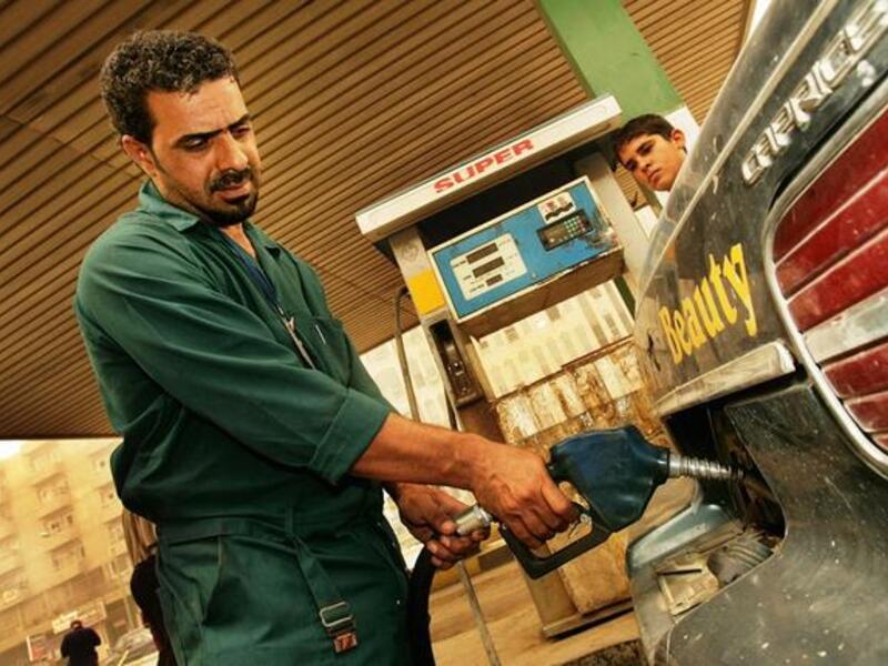 Iraqi man pumps gasoline at station