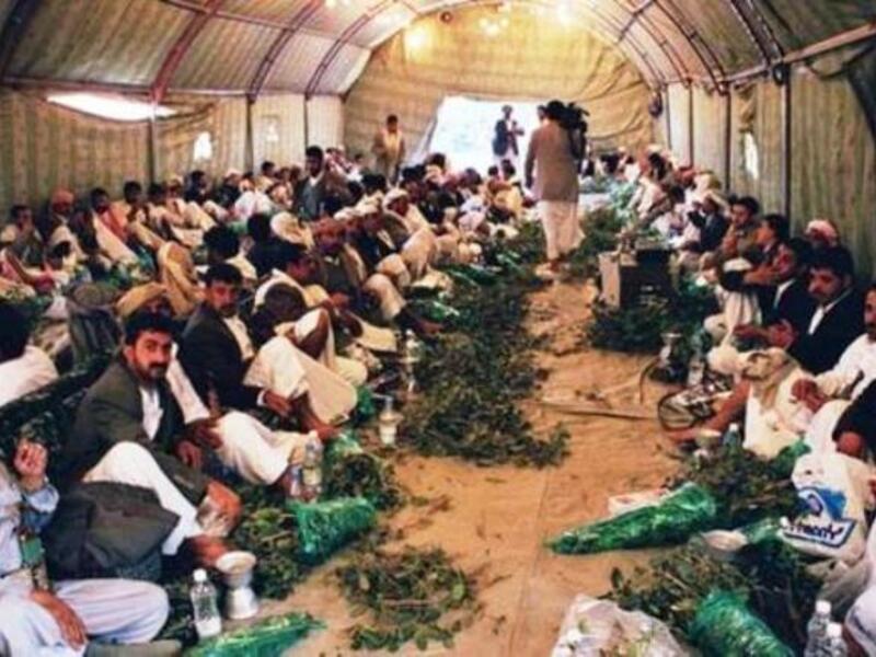 Yemenis gather to chew Qat in a tent