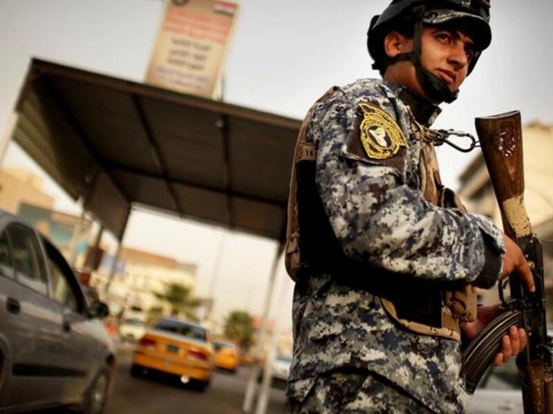 An Iraqi soldier wields a gun