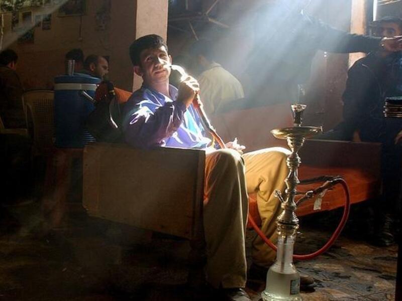 Smoking Ramadan: An Arab smoking a hookah pipe in a sheesha cafe
