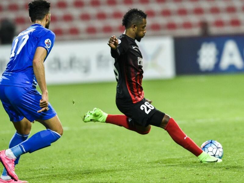 Abdulaziz Haikal (R) of UAE's Al-Ahli FC kicks the ball past Ali Ghorbani of Iran's Esteghlal FC during their AFC Champions League qualifying football match between UAE's Al-Ahli and Iran's Esteghlal FC at Al-Rashid Stadium in Dubai on February 20, 2017.
STRINGER / AFP