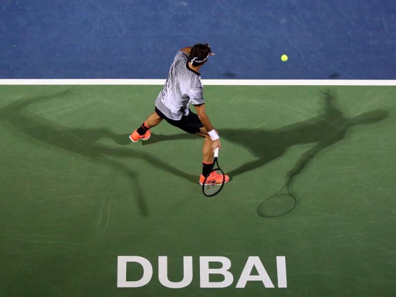 Roger Federer of Switzerland returns the ball to France's Benoit Paire during their ATP tennis match as part of the Dubai Duty Free Championships on February 27, 2017. MAHMOUD KHALED / AFP