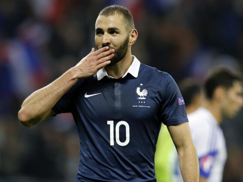 (FILES) This file photo taken on October 09, 2015 shows French forward Karim Benzema celebrating after scoring a goal during the friendly football match between France and Armenia on October 8, 2015. The judicial review of Karim Benzema, indicted in the sex-tape blackmailing affair against Mathieu Valbuena, was lifted on March 11, 2016, by the Versailles Court of Appeal, opening the way to its come-back in the French national team for Euro 2016.