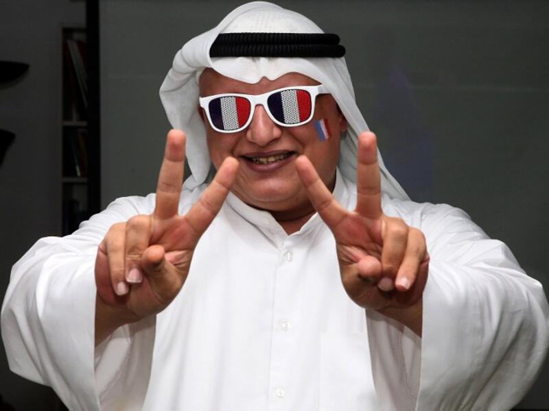 A French football team supporter flashes the sign for victory as he watches the UEFA Euro 2016 final football match between France and Portugal, hosted in Paris, at the French Institue in Kuwait City on July 10, 2016.
YASSER AL-ZAYYAT / AFP