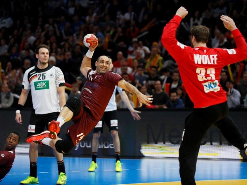 Qatar's pivot Bassel Alrayes (L) jumps to shoot on goal against Germany's goalkeeper Andreas Wolff during the 25th IHF Men's World Championship 2017 eighth final handball match Germany vs Qatar on January 22, 2017 at the AccorHotels Arena in Paris.
THOMAS SAMSON / AFP