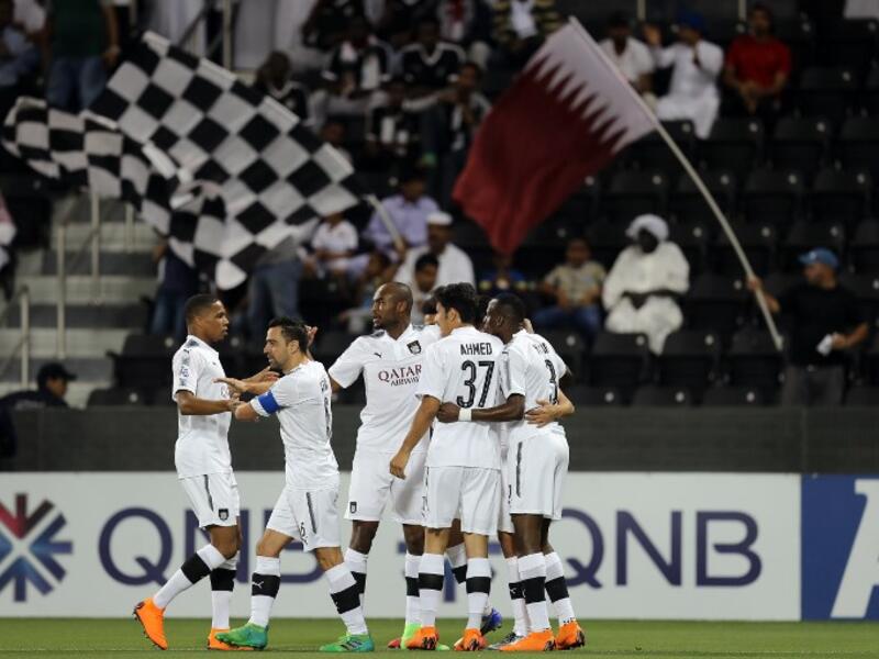 Al-Sadd's forward Baghdad Bounedjah is congratulated by his teammate after scoring during the AFC Champions League football match between Qatar's al-Sadd and UAE's al-Wasl at the Jassim bin Hamad Stadium in Doha, on April 2, 2018.
KARIM JAAFAR / AFP