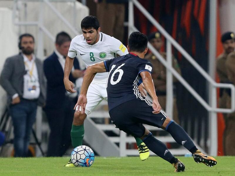 Saudi Arabia's Yahia Alshehri (L) dribbles against Japan's Hotaru Yamaguchi during the FIFA World Cup 2018 qualification match between Saudi Arabia and Japan at King Abdullah bin Abdulaziz Stadium in Jeddah on September 5, 2017.
STR / AFP