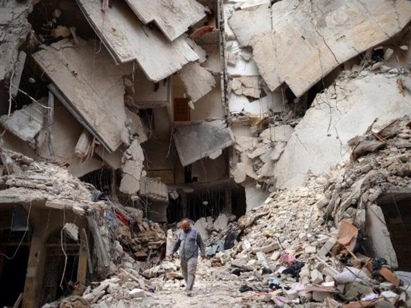 A man walks amid destruction in Aleppo, Syria (AFP/ Dimitar Dilkoff)