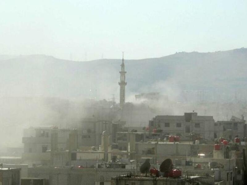 A handout image released by the Syrian opposition's Shaam News Network shows smoke above buildings following what Syrian rebels claim to be a toxic gas attack by pro-government forces in eastern Ghouta, on the outskirts of Damascus on August 21, 2013. "AFP PHOTO / HO / SHAAM NEWS NETWORK" 