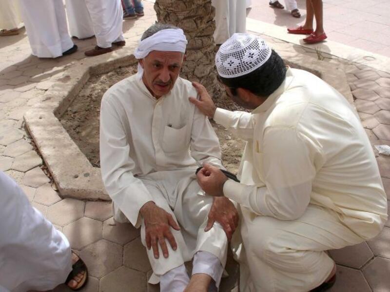 A Kuwaiti man is consoled at the site of Friday's Daesh-perpetrated bombing on a Shiite mosque in Kuwait City.  (AFP/Yasser al-Zayyat)