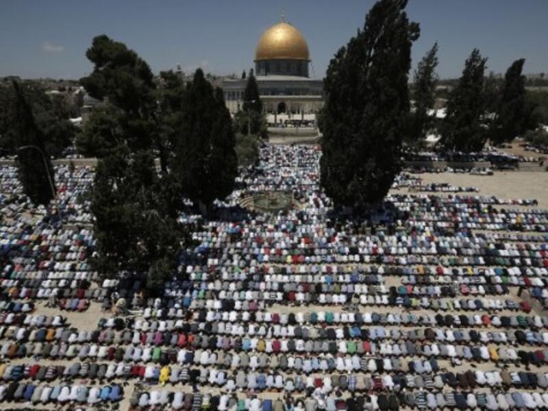 Worshippers at the Al Aqsa compound in Jerusalem participate in this year's first Friday prayers of the Muslim holy month of Ramadan.  Ramadan marks a brief period of eased travel restrictions for many Palestinians.  (AFP/Ahmad Gharabli)
