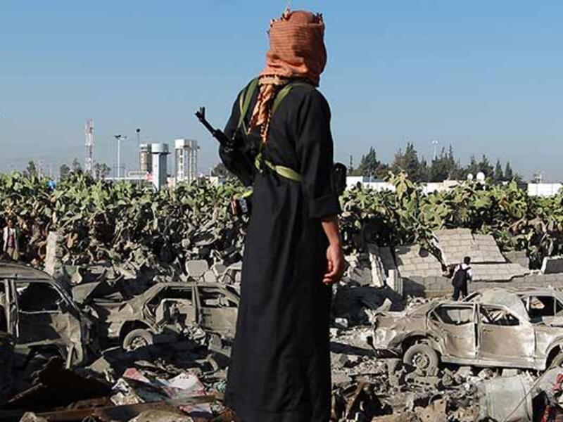 A Yemeni man observes the damage following a Saudi-led coalition airstrike near Sanaa's airport.  (AFP/File)