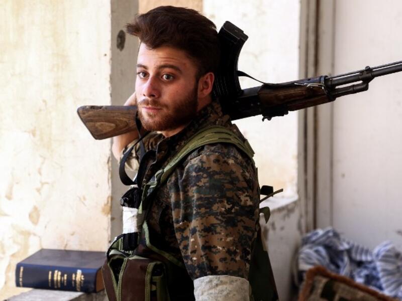 A Syrian Democratic Forces fighter in the suburb of al-Rumaniya on the western outskirts of Raqqa on June 27, 2017 after the area was seized from Daesh. (Delil Souleiman/AFP)