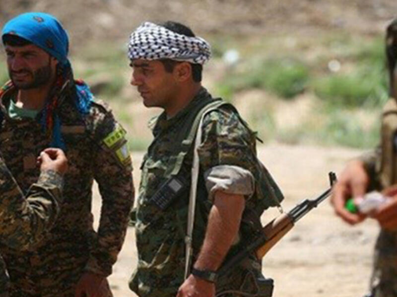 Members of the YPG and Syrian Democratic Forces in a distrcit of Raqqa on June 11. (AFP/Delil Souleiman)
