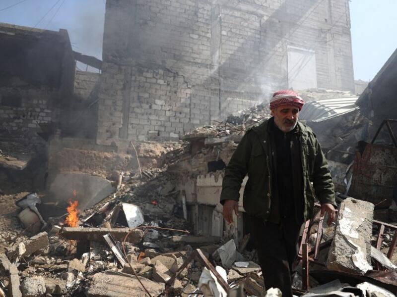 A Syrian man inspects the damage following reported government airstrike on the rebel-held town of Douma, on the eastern outskirts of the capital Damascus, on February 26, 2017. (AFP/Abd Doumany)