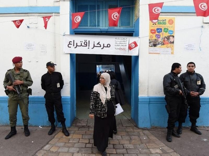 A Tunisian woman exits a Tunis polling station after voting in the first round of presidential elections on November 23, 2014. (AFP/File)