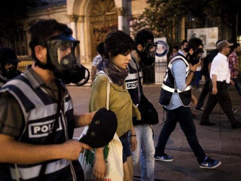 Turkish policeman detain a protestor during a protest on Istiklal Avenue in Istanbul on July 8 (AFP)
