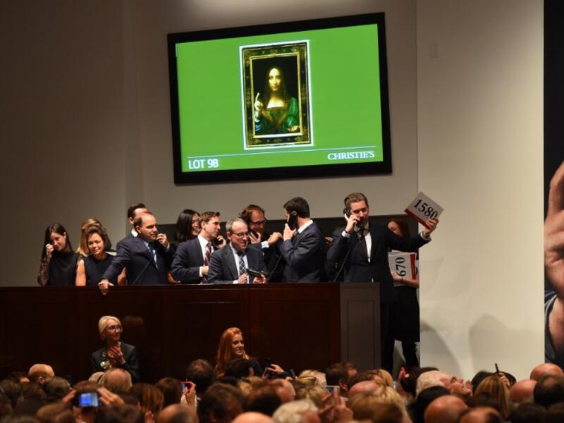 Christie's employees take bids for Leonardo da Vinci’s "Salvator Mundi" at Christie's New York November 15, 2017 (Timothy A. Clary/AFP)