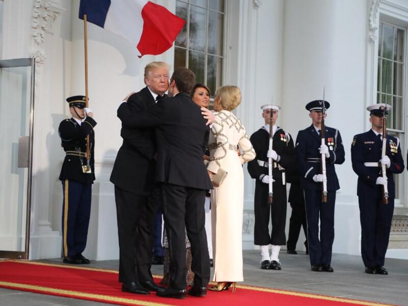 US President Donald Trump and First Lady Melania Trump greet French President Emmanuel Macron and his wife, Brigitte Macron, for a State Dinner at the White House in Washington, DC, April 24, 2018. 
ludovic MARIN / AFP