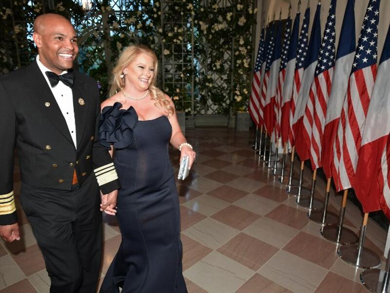 Surgeon General Jerome Adams and his wife Lacey Adams arrive in the “Booksellers Area” of the White House to attend a state dinner honoring France's President Emmanuel Macron on April 24, 2018 in Washington, DC. 
MANDEL NGAN / AFP