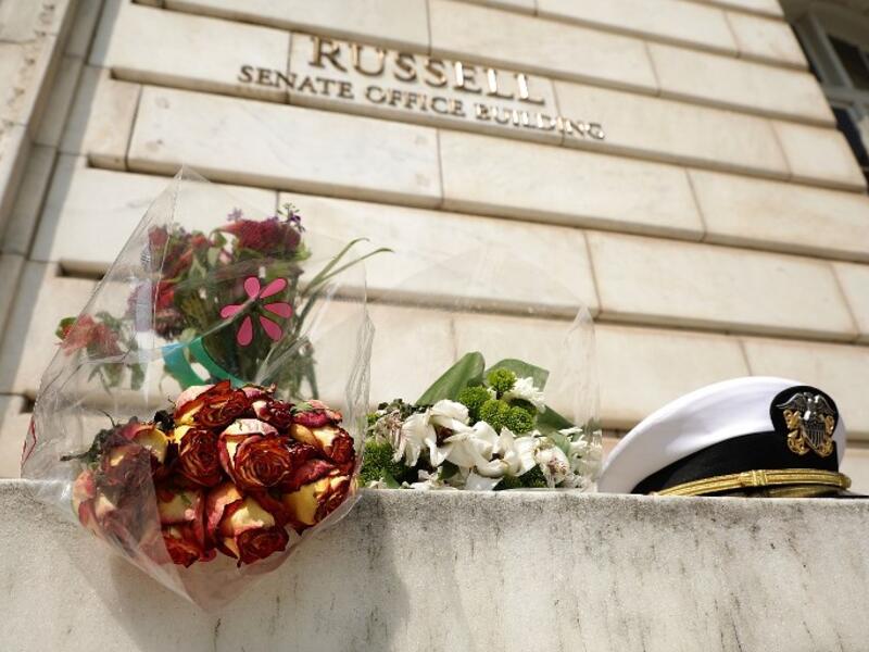An impromptu memorial of flowers and a U.S. Navy officers hat stands outside of the Russell Senate Office Building in honor of Sen. John McCain (R-AZ) August 27, 2018 in Washington, DC. (AFP)