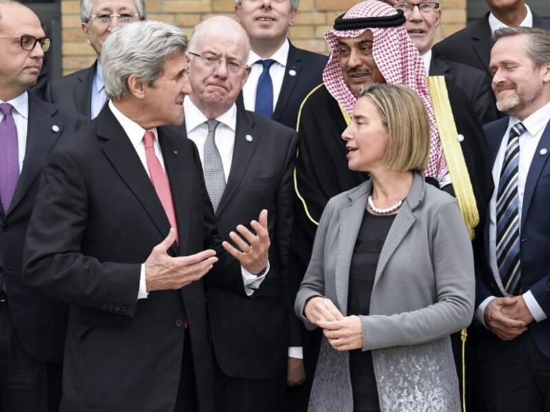 US Secretary of State John Kerry speaks to other conference delegates (Bertrand Guay/Pool/AFP)