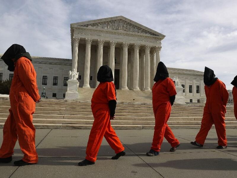 Protesters gather in front of the U.S. Supreme Court to mark 15 years since the first prisoners were brought to the U.S. detention facility in Guantanamo Bay, Cuba on January 11, 2017 in Washington, DC. (AFP/Joe Readle)
