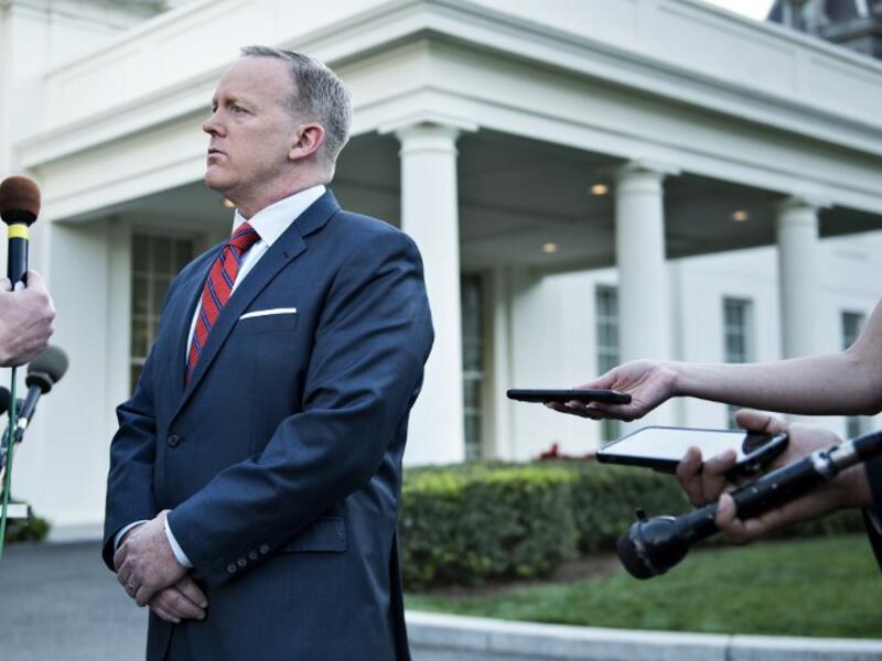 White House Press Secretary Sean Spicer speaks to a reporter about a comparison he made between Syria's President Bashar al-Assad and Hitler during an earlier press briefing at the White House April 11, 2017 in Washington, DC. (AFP/Brendan Smialowski)